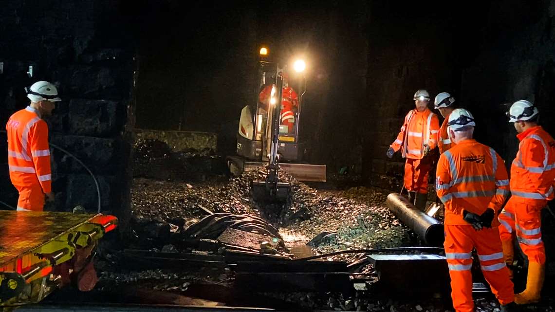 Excavator digging out new drainage channel in Cowburn Tunnel