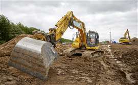 An yellow excavator digging earth