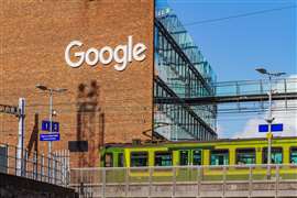 Google office building, European headquarters in Dublin, Ireland with DART electric train passing