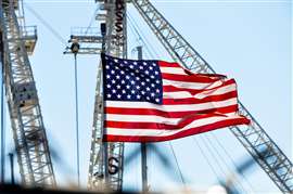 American flag surrounded by construction cranes