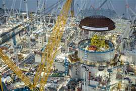 The world's biggest land-based crane, Big Carl, lifted the 245-tonne domed roof onto the first reactor building at Hinkley Point C.