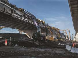 A row of excavators taking down the Champlain Bridge