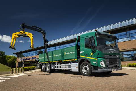 Green truck eith black and yellow loader crane