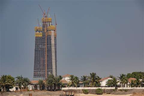 The under-construction Jeddah Tower on the horizon, surrounded by multiple tower cranes assisting in its construction.